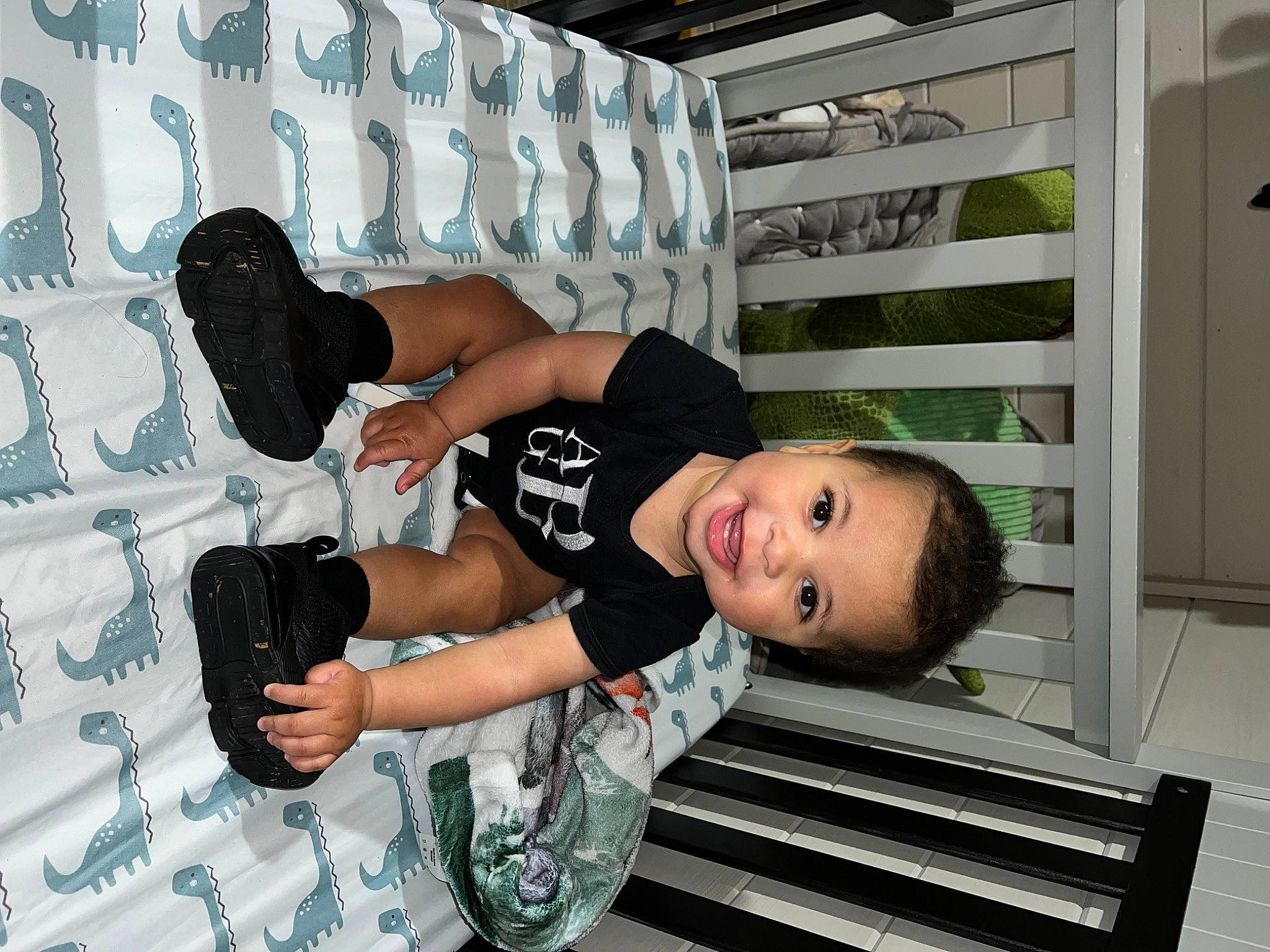 Atlas is registered to the contest to win money with this photo: ceiling, child, elbow, flash_photography, fun, happy, human_leg, knee, leisure, pattern, person, room, shorts, smile, sneakers, t_shirt, thigh, toddler, white