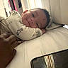 Princeton is registered to the contest to win money with this photo: baby, smile, bed, hand, phone, reflection, light, indoors, person, clothing, blanket, curtain, furniture, portrait, face, child, cozy, resting, casual, home