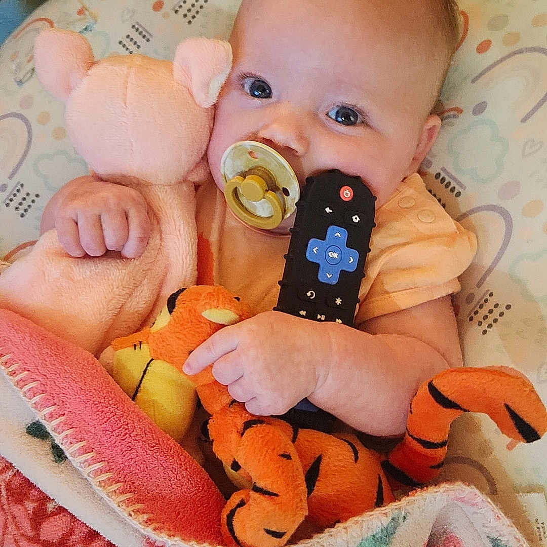 Savannah is registered to the contest to win money with this photo: baby, blanket, bodypart, couch, doll, electronics, face, finger, furniture, hand, head, homedecor, mobilephone, newborn, person, phone, photography, portrait, quilt, toy