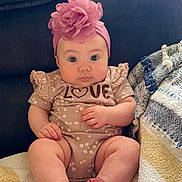 Sophia is registered to the contest to win money with this photo: baby, infant, child, sitting, headband, pink, socks, love, couch, blanket, cozy, cute, clothing, indoor, portrait, face, expression, soft, comfort, adorable