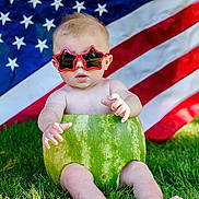 Waylon is registered to the contest to win money with this photo: baby, watermelon, sunglasses, star_shaped, american_flag, grass, outdoor, summer, cute, child, funny, patriotic, green, red, blue, skin, nature, holiday, celebration, person