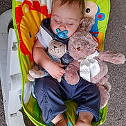Alexander joined the competition — help win amazing prizes! baby, sleeping, pacifier, stuffed_animal, toy, baby_rocker, colorful, lion, monkey, clothing, carpet, foot, hand, cute, infant, child, resting, indoor, soft_toy, peaceful