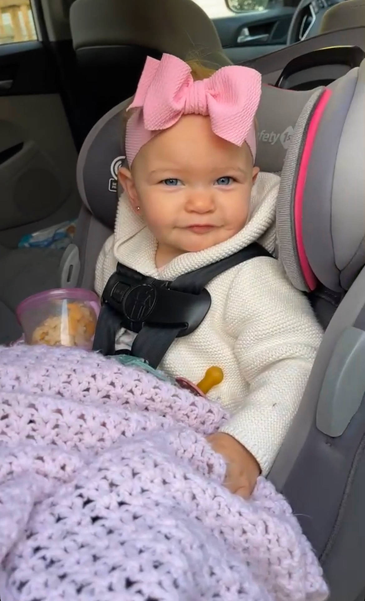 Kenzie joined the competition — help win amazing prizes! auto_part, baby, baby_products, baby_toddler_clothing, car_seat, car_seat_cover, child, comfort, family_car, fashion_accessory, happy, headwear, linens, pattern, person, purple, sitting, sleeve, smile, steering_wheel