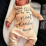 Aubrey joined the competition — help win amazing prizes! newborn, baby, infant, onesie, clothing, text, message, cushion, lying_down, peaceful, soft_lighting, portrait, child, sleepy, indoor, cute, human, small, toddler, love