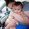 Juan is registered to the contest to win money with this photo: baby, adult, car_interior, embrace, diaper, sneakers, love, candid, person, window, seat, clothing, skin, hand, footwear, vehicle, interior, portrait, tenderness, casual