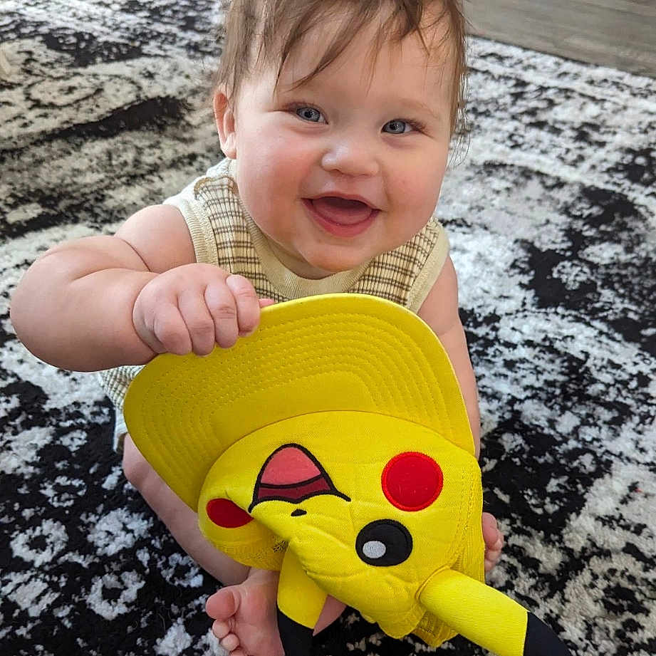 Jameson joined the competition — help win amazing prizes! baby, bodypart, clothing, costume, dress, face, happy, head, homedecor, laughing, mouth, person, photography, plush, portrait, sitting, smile, t_shirt, teeth, toy