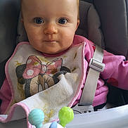 Eloane participe au concours pour gagner de l'argent avec cette photo : baby, bib, high_chair, toy, face, blue_eyes, pink_clothing, seatbelt, mickey_mouse, minnie_mouse, child, indoor, infant, cute, messy, feeding, closeup, person, playful, smiling