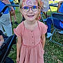 Angèle participe au concours pour gagner de l'argent avec cette photo : child, girl, face_paint, glasses, pink_dress, smiling, outdoor, grass, people, event, chair, stroller, happy, summer, sunlight, portrait, casual, festival, young, fun