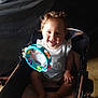 baby, child, stroller, toy, tambourine, smiling, indoor, bottle, playing, cute, happy, person, infant, seat, colorful, plastic, floor, light, shadow, portrait