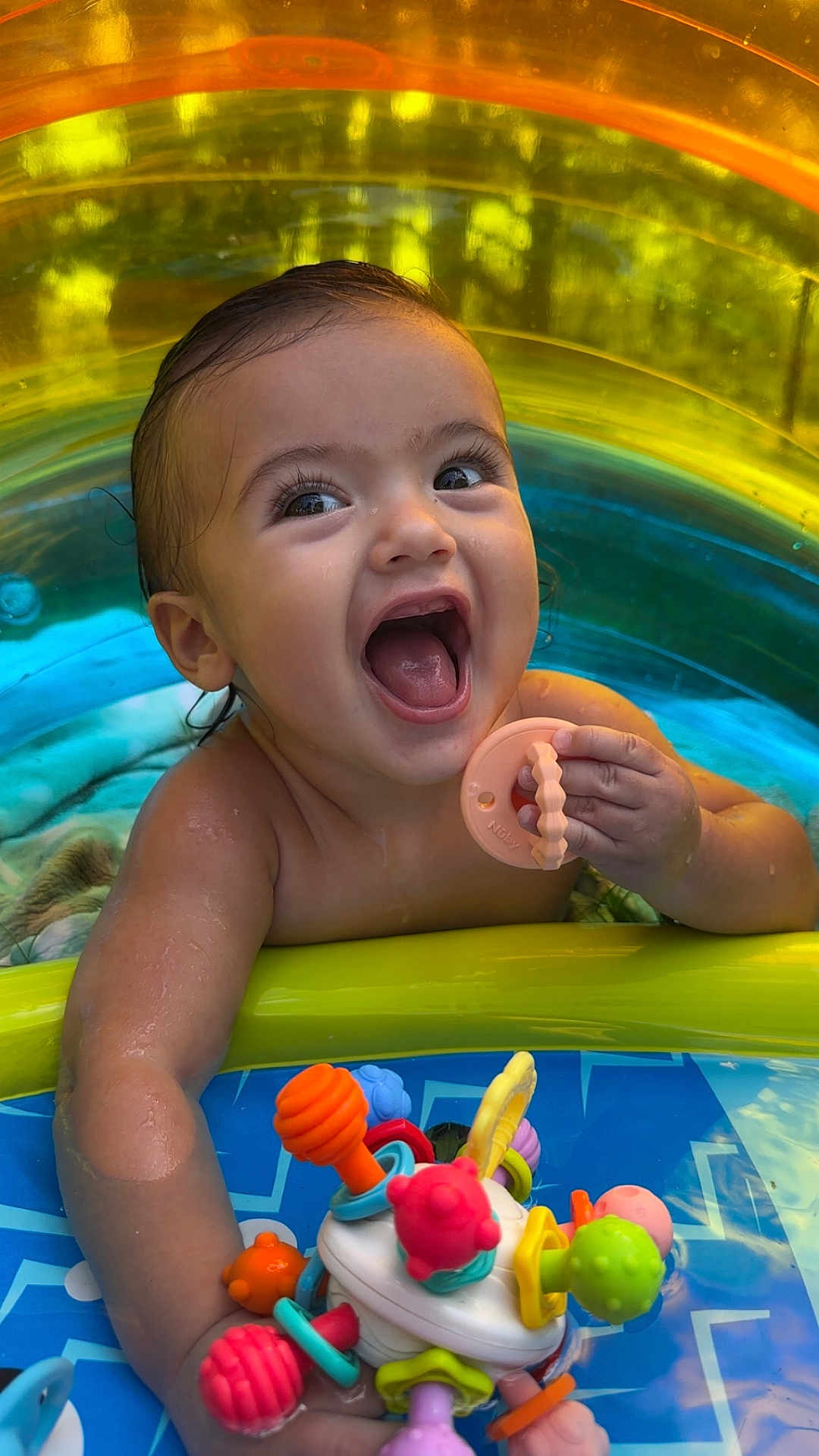 Baker joined the competition — help win amazing prizes! baby, child, pool, toy, water, smile, happy, colorful, teething_toy, inflatable, summer, play, fun, cute, outdoor, splash, skin, face, hand, expression