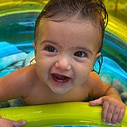 Baker joined the competition — help win amazing prizes! baby, child, infant, water, pool, inflatable_pool, toy, colorful, wet_hair, smiling, happy, outdoor, summer, play, fun, hand, face, skin, closeup, bright