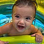 baby, child, infant, water, pool, inflatable_pool, toy, colorful, wet_hair, smiling, happy, outdoor, summer, play, fun, hand, face, skin, closeup, bright