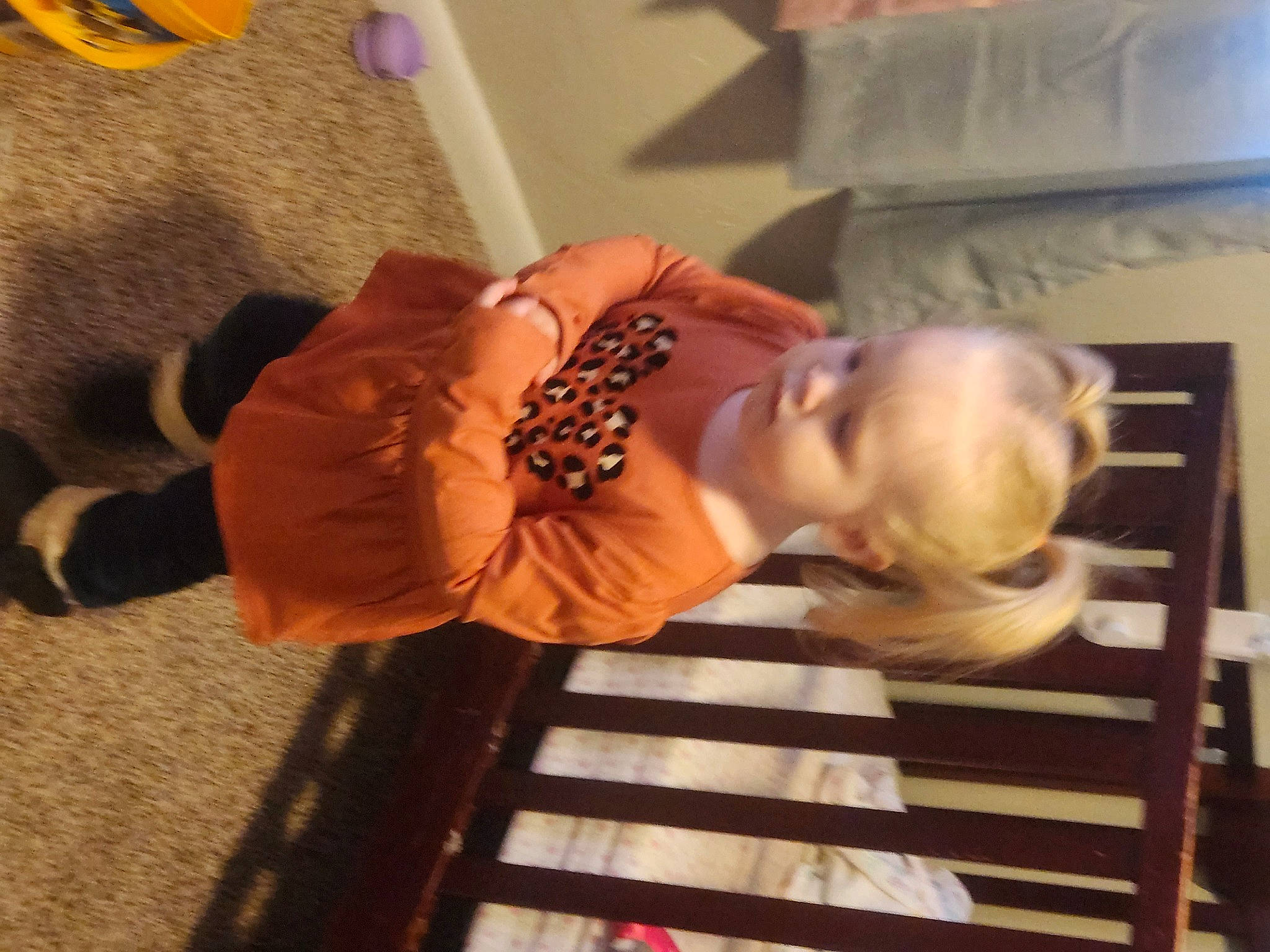 Ava-mae is registered to the contest to win money with this photo: abdomen, child, comfort, dress, elbow, eyewear, finger, flooring, hand, happy, hardwood, human_leg, joint, person, sleeve, thigh, thumb, toddler, trunk, wood