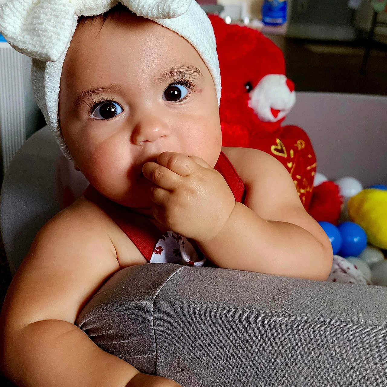 Adaline is registered to the contest to win money with this photo: architecture, baby, bodypart, bonnet, cap, clothing, couch, eating, face, finger, food, furniture, hand, happy, hat, head, person, photography, portrait, smile