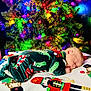 Anakin is registered to the contest to win money with this photo: baby, sleeping, christmas_tree, holiday_lights, pajamas, blanket, festive, colorful, indoor, infant, face, child, decorations, seasonal, cozy, peaceful, home, celebration, cute, toddler