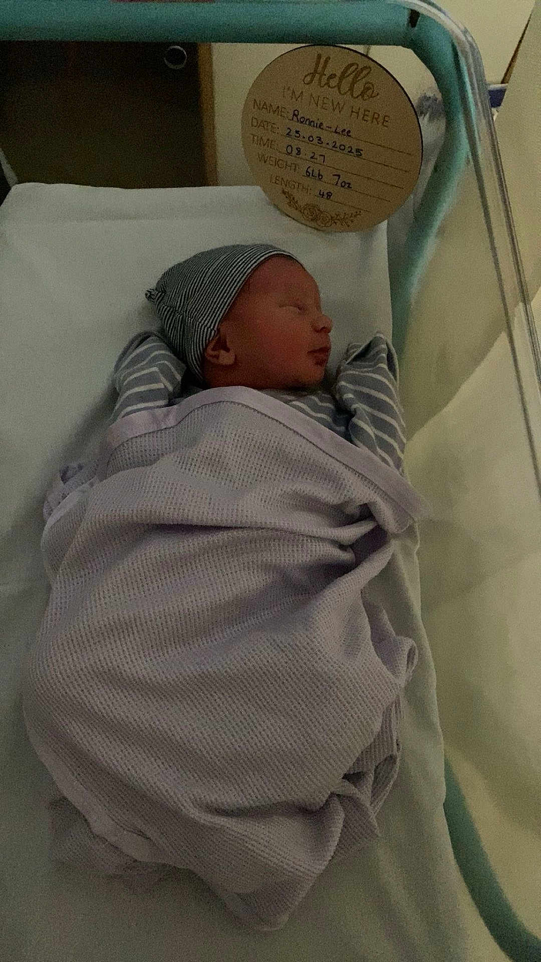 Ronnie-Lee is registered to the contest to win money with this photo: newborn, baby, sleeping, blanket, hospital, bassinet, cap, infant, portrait, child, bed, rest, cute, peaceful, sign, text, wrapped, soft, indoors, person