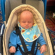 Ronnie-Lee is registered to the contest to win money with this photo: baby, sleeping, car_seat, blue_clothing, bib, infant, blanket, indoor, child, toddler, seatbelt, comfort, peaceful, cute, face, hands, soft, patterned_carpet, resting, cozy