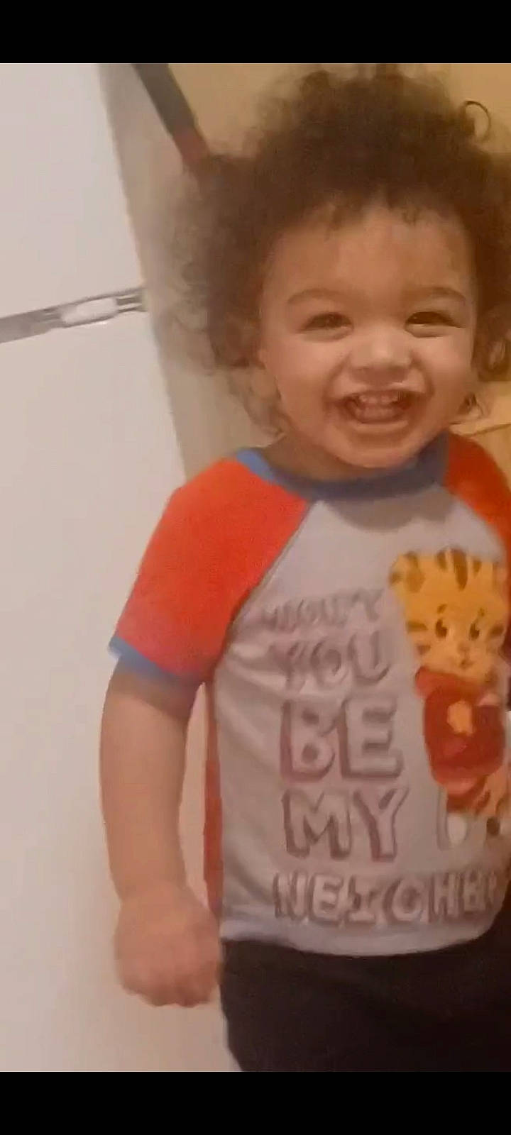 Niklaus is registered to the contest to win money with this photo: arm, baby_toddler_clothing, cheek, chin, ear, eyebrow, forehead, gesture, happy, human_body, iris, joint, lip, mouth, neck, nose, outerwear, person, sleeve, smile