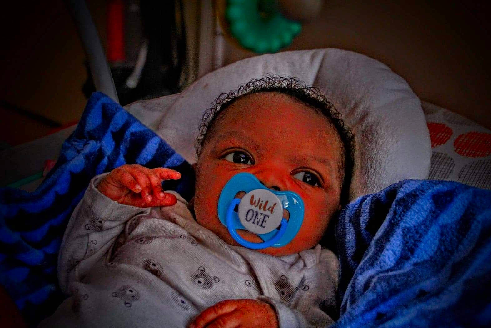 Carmelo is registered to the contest to win money with this photo: baby, baby_products, baby_toddler_clothing, bedtime, cheek, child, comfort, eye, eyebrow, fun, hat, head, headgear, infant_bed, linens, nose, person, room, skin, textile