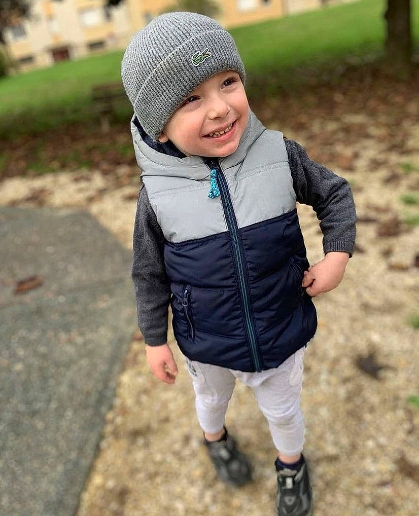 Ruben participe au concours pour gagner de l'argent avec cette photo : baby_toddler_clothing, cap, child, eye, face, fun, grass, happy, headgear, headwear, jacket, joy, knit_cap, leisure, people_in_nature, person, plant, recreation, sleeve, smile