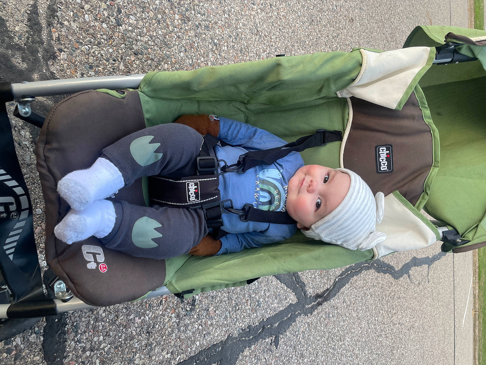 Everett is registered to the contest to win money with this photo: auto_part, baby, baby_carriage, baby_products, baby_toddler_clothing, child, comfort, grass, headwear, person, personal_protective_equipment, recreation, sitting, toddler