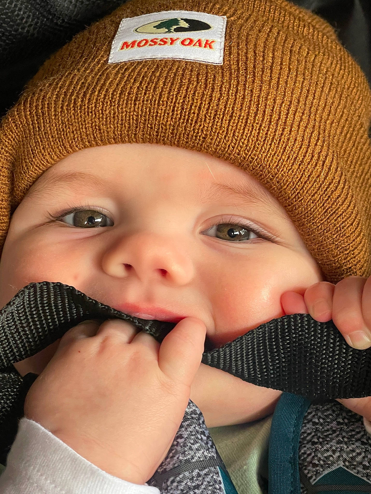 Everett joined the competition — help win amazing prizes! baby, cap, cheek, chin, eye, eyebrow, eyelash, face, facial_expression, finger, gesture, headgear, headwear, human_body, lip, mouth, nose, organ, outerwear, person