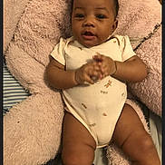 Divinity Chin Marks joined the competition — help win amazing prizes! baby, infant, child, pink_bows, onesie, stuffed_animal, plush_toy, clapping, bed, blanket, cute, indoors, smiling, happy, lying_down, soft_toy, cozy, person, portrait, young_child