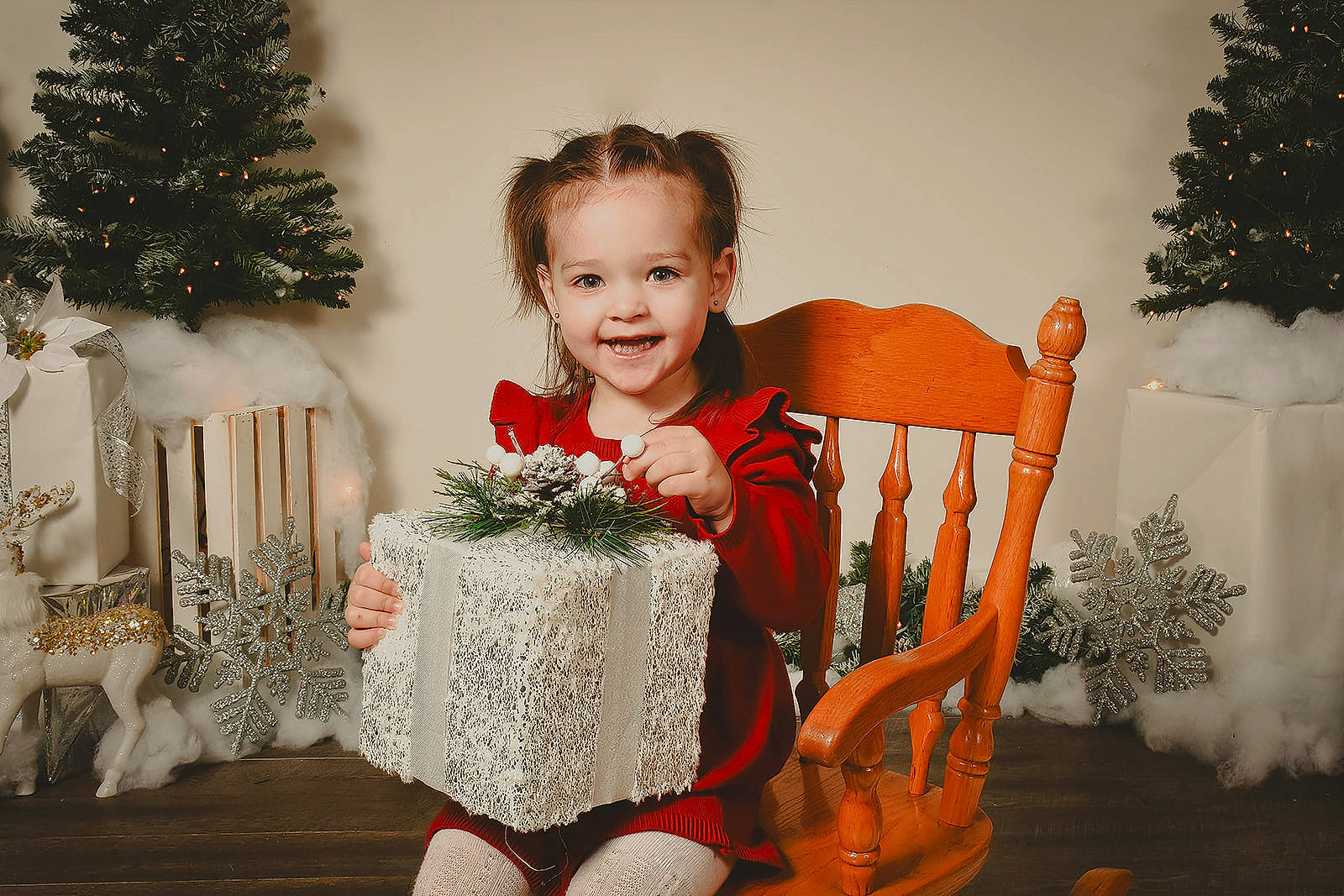 Alayah is registered to the contest to win money with this photo: baby_toddler_clothing, chair, child, christmas, christmas_decoration, christmas_ornament, christmas_tree, event, happy, holiday, joy, ornament, person, plant, sitting, smile, standing, toddler, tradition, tree