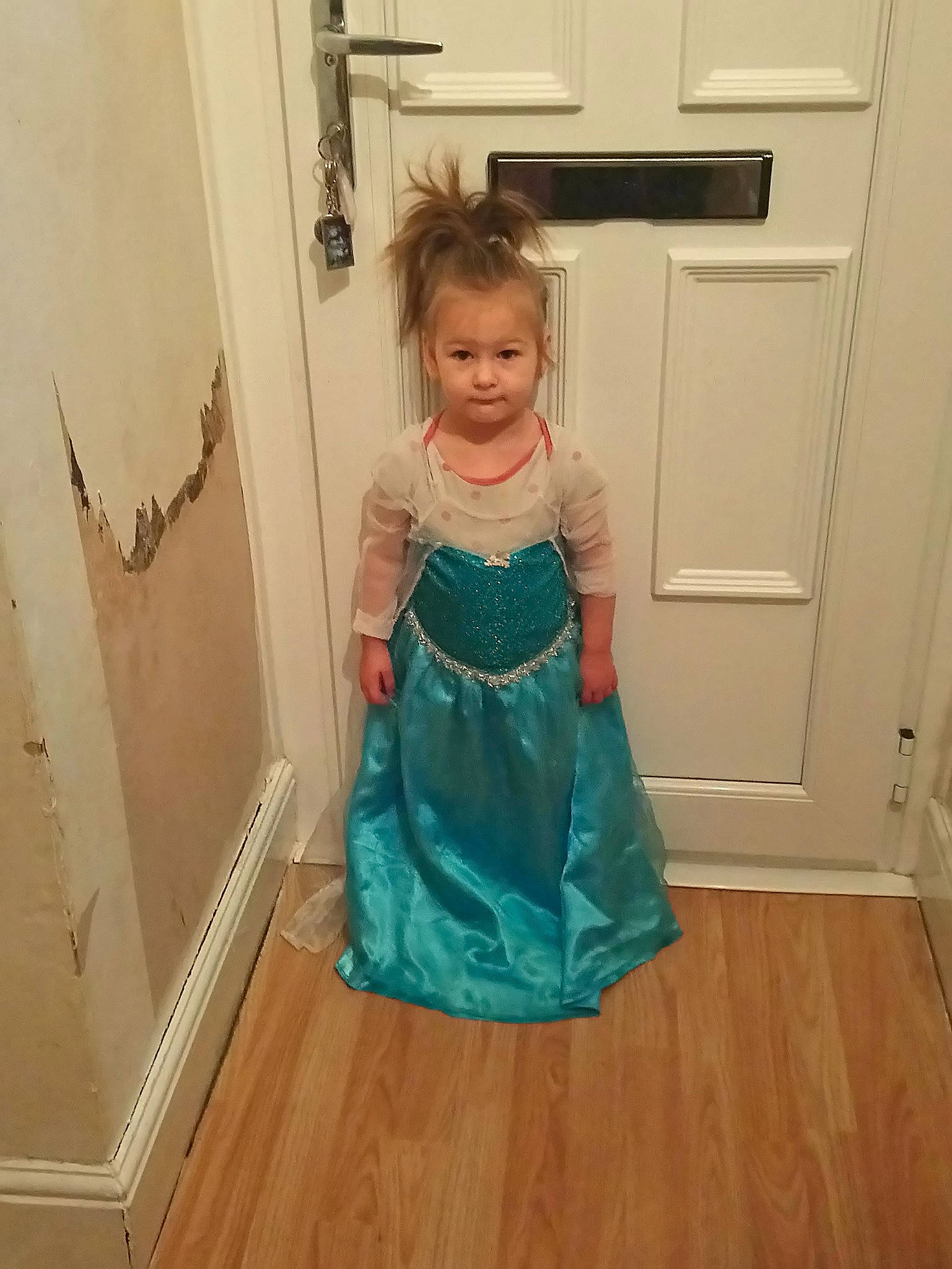 Eve is registered to the contest to win money with this photo: blue, child, clothing, cocktail_dress, costume, dance_dress, day, dress, floor, flooring, girl, gown, hair, person, shoulder, standing, textile, toddler, turquoise