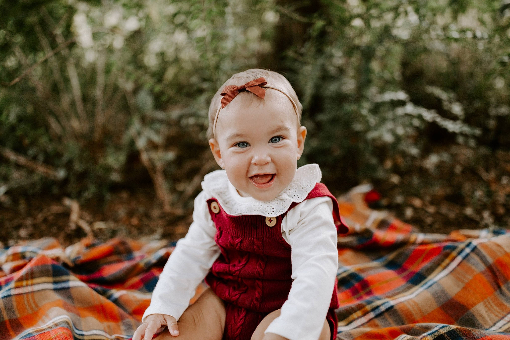 Marcella is registered to the contest to win money with this photo: baby, baby_toddler_clothing, child, dress, flash_photography, fun, grass, happy, joy, leisure, pattern, people_in_nature, person, plaid, plant, sitting, sleeve, smile, tartan, textile