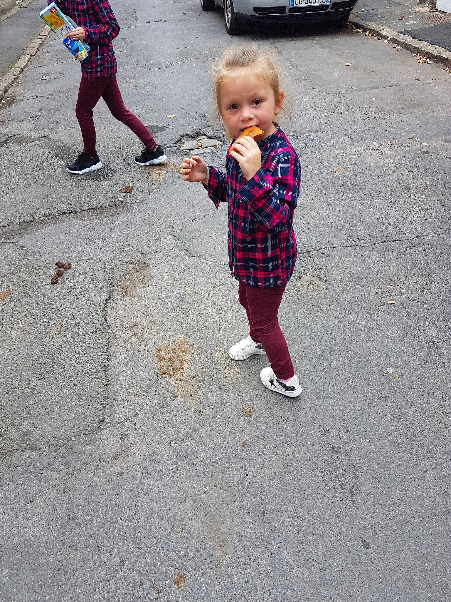 Chloé participe au concours pour gagner de l'argent avec cette photo : asphalt, child, design, fun, girl, material, pattern, pedestrian, person, plaid, play, recreation, shoe, sidewalk, snapshot, standing, street, tartan, toddler, vacation