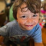 Greyson is registered to the contest to win money with this photo: child, boy, smiling, face, brown_eyes, hair, tshirt, spiderman, indoor, table, wood, happy, portrait, closeup, casual, clothing, person, cute, young, messy_hair