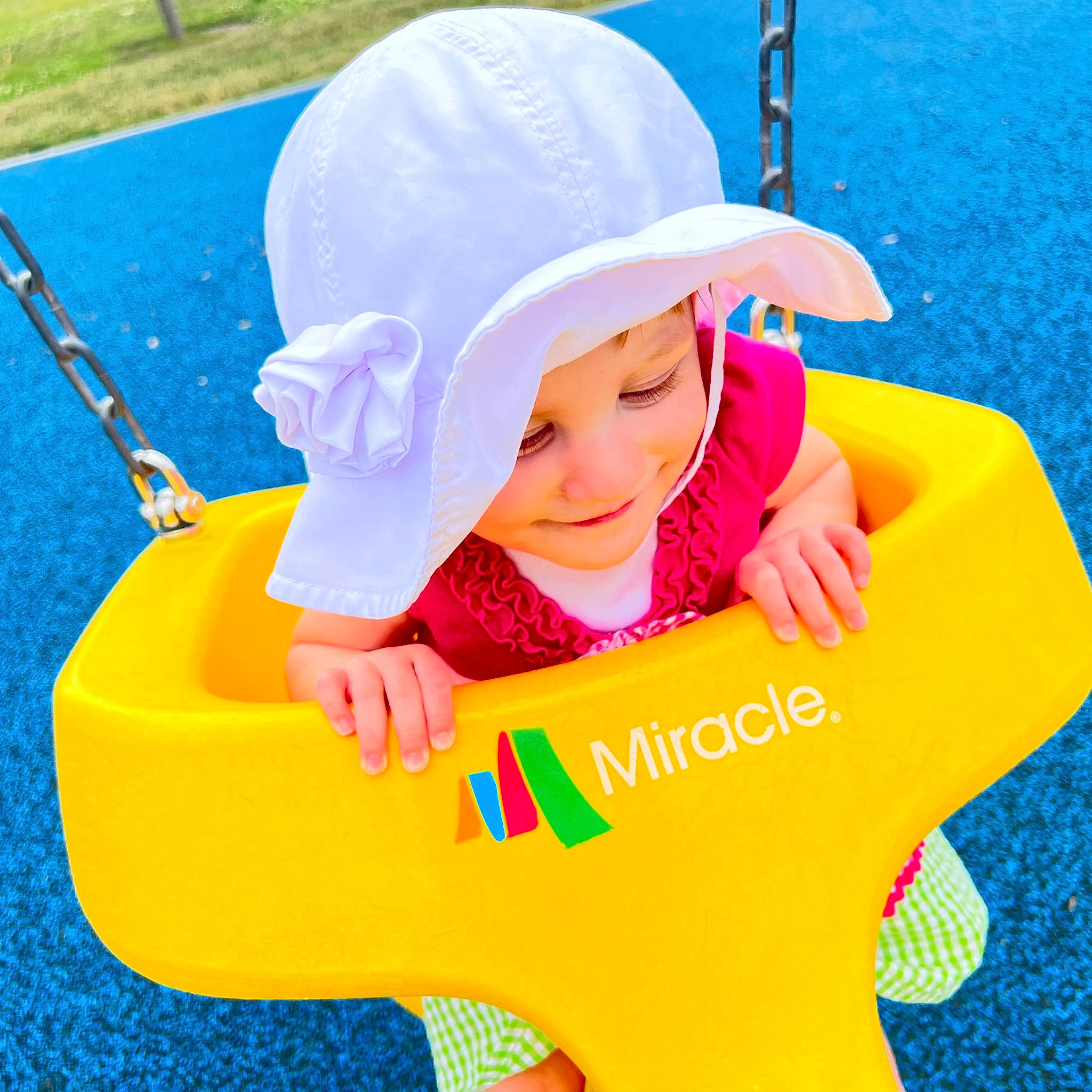 Cecilia is registered to the contest to win money with this photo: baby, baby_products, baby_toddler_clothing, cap, child, electric_blue, fun, grass, happy, hat, leisure, outdoor_play_equipment, people_in_nature, person, product, recreation, sitting, smile, sun_hat, toddler