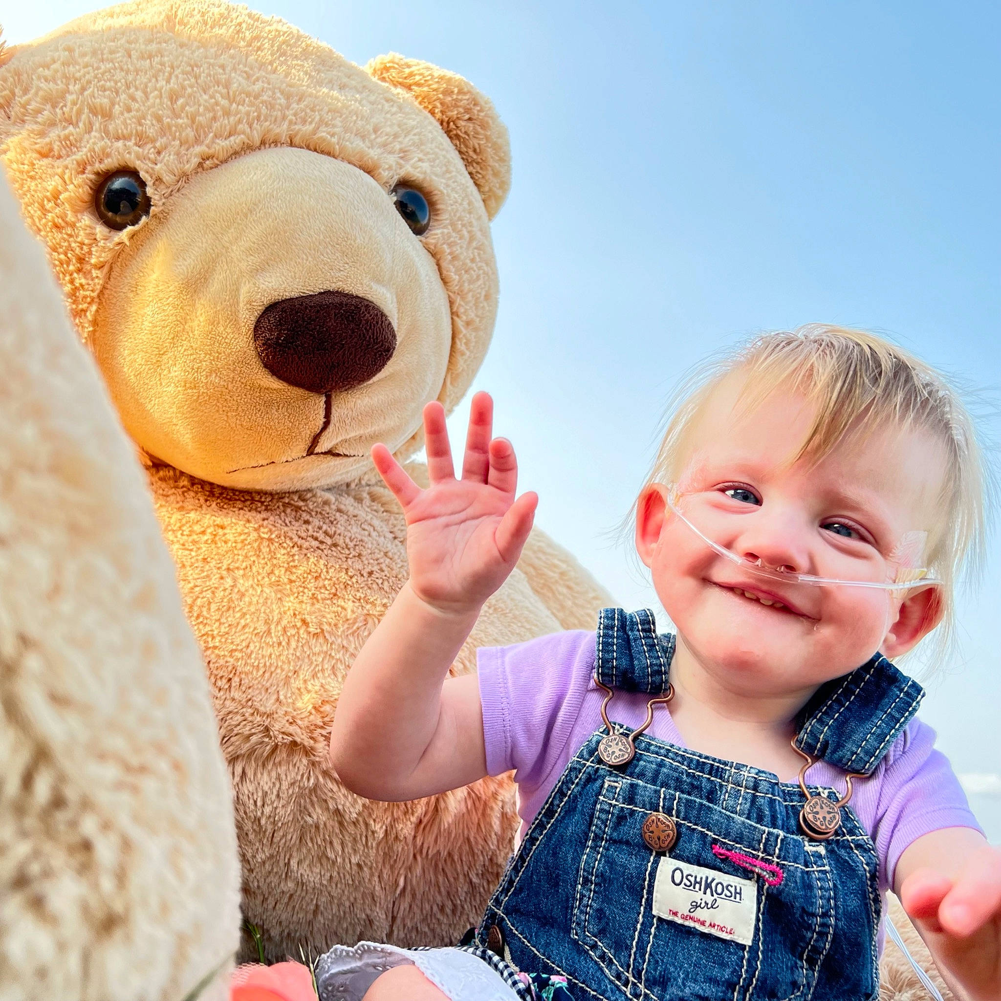 Cecilia is registered to the contest to win money with this photo: baby, baby_toddler_clothing, facial_expression, finger, gesture, happy, head, joy, nose, people_in_nature, person, skin, sky, sleeve, smile, snout, stuffed_toy, summer, teddy_bear, textile