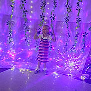 Ashy joined the competition — help win amazing prizes! child, girl, dress, smiling, fairy_lights, purple_light, vines, indoor, floor, happy, standing, decorations, magic, glow, young, person, playful, lighting, celebration, background