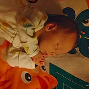 Charlee joined the competition — help win amazing prizes! baby, sleeping, onesie, floral, infant, play_mat, cartoon, octopus, fish, colorful, cozy, child, peaceful, indoors, portrait, cute, young, resting, soft_lighting, nursery