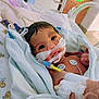 Journe'E is registered to the contest to win money with this photo: newborn, baby, hospital, medical_tubes, monitoring_sensors, wrapped_in_blanket, face, eyes, infant, healthcare, patient, bed, cute, small, towel, smileys, closeup, lying_down, indoors, person