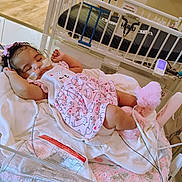 Journe'E joined the competition — help win amazing prizes! baby, bed, blanket, booties, child, cozy, crib, cute, face, healthcare, hospital, indoors, infant, medical_tubes, monitor, person, pink_clothing, resting, sleeping, soft_lighting