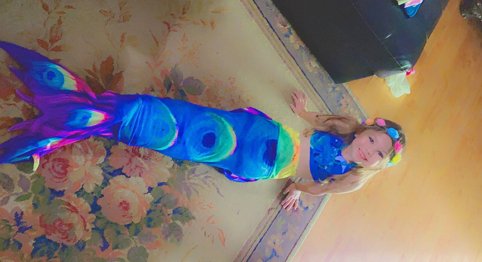 Skylee is registered to the contest to win money with this photo: blue, ceiling, costume, electric_blue, fashion_accessory, feather, flower, fun, headwear, joy, leisure, magenta, paint, party_supply, person, pink, plant, plaster, purple, room