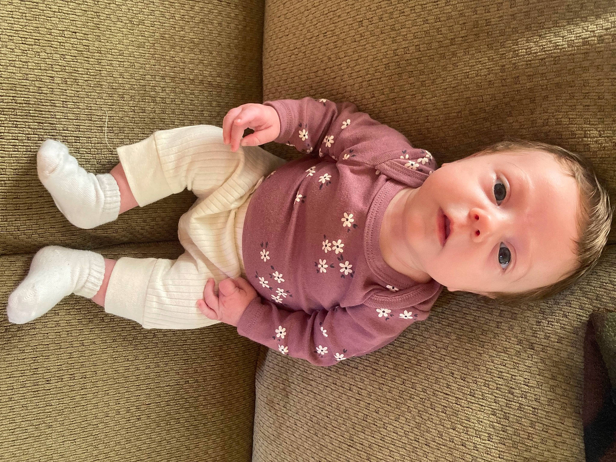 Brynlee joined the competition — help win amazing prizes! baby, baby_products, baby_safety, baby_sleeping, baby_toddler_clothing, cheek, child, clothing, comfort, face, flooring, human_body, mammal, nose, pattern, person, sitting, skin, sleeve, textile