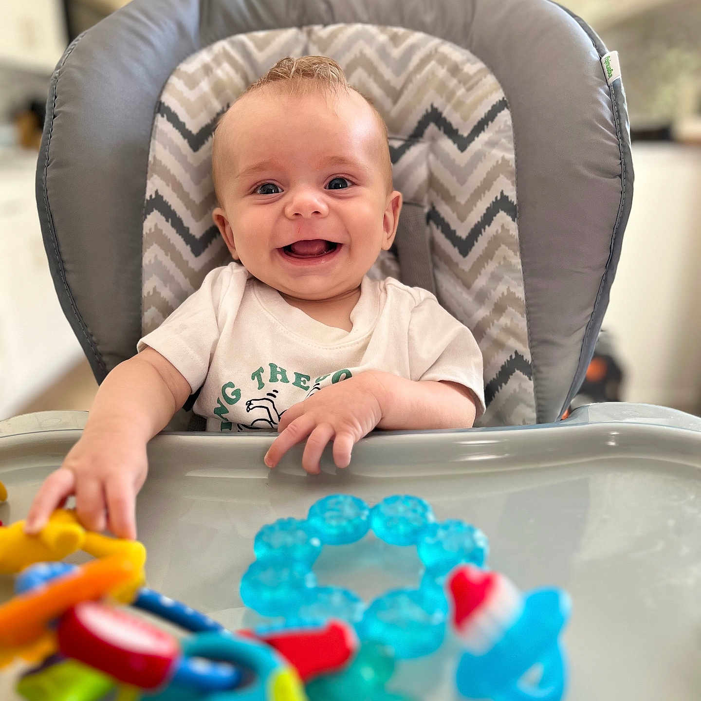 Larsyn is registered to the contest to win money with this photo: baby, babylaughing, bodypart, chair, clothing, crib, cutlery, face, finger, furniture, hand, happy, head, infantbed, person, photography, portrait, smile, t_shirt, toy