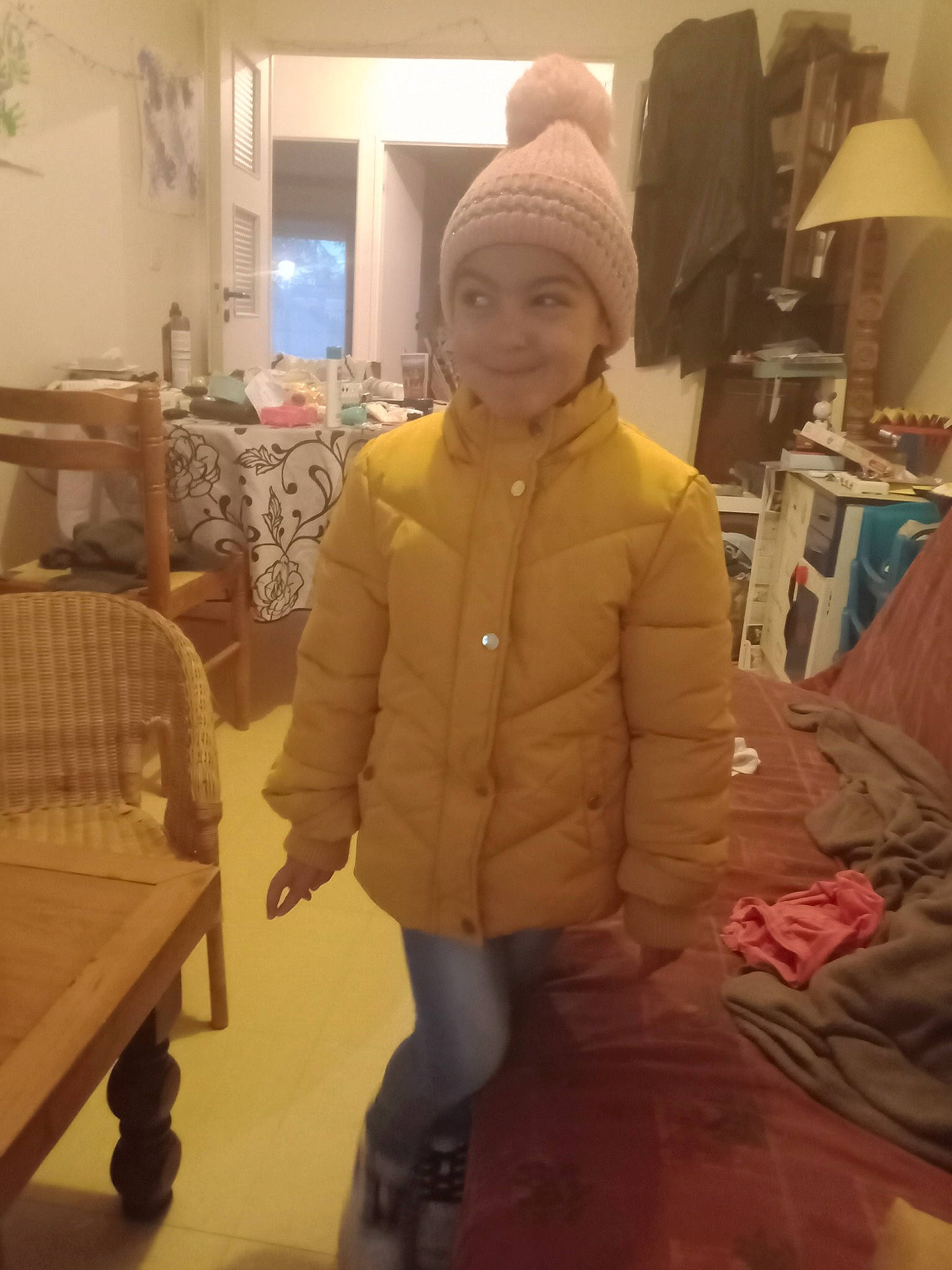 Zoé a rejoint le concours — aidez-le/la à gagner de superbes lots ! baby, baby_toddler_clothing, cap, child, comfort, floor, flooring, fur, fur_clothing, hat, headwear, hoodie, houseplant, jacket, joy, person, room, selfie, sitting, sleeve