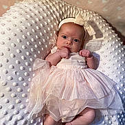 Maddie is registered to the contest to win money with this photo: baby, infant, tutu, pink_dress, headband, bow, blanket, textured_blanket, newborn, cute, lying_down, closeup, indoors, soft_lighting, small_hands, baby_face, portrait, cozy, sleepwear, adorable