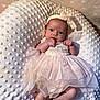 baby, infant, tutu, pink_dress, headband, bow, blanket, textured_blanket, newborn, cute, lying_down, closeup, indoors, soft_lighting, small_hands, baby_face, portrait, cozy, sleepwear, adorable