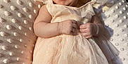 Maddie joined the competition — help win amazing prizes! baby, infant, dress, headband, smile, happy, blanket, soft_texture, tulle, cute, portrait, lying_down, skin, hand, foot, indoor, child, fashion, adorable, person