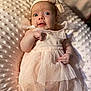 Maddie is registered to the contest to win money with this photo: baby, infant, dress, headband, bow, blanket, soft_texture, pink, tulle, cute, portrait, child, newborn, lying_down, curious, hand, face, expression, indoors, closeup
