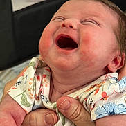 Ryhlee is registered to the contest to win money with this photo: baby, infant, smiling, laughing, child, hands, onesie, floral_pattern, cute, happy, cheeks, skin, person, closeup, portrait, newborn, joyful, expression, clothing, indoor