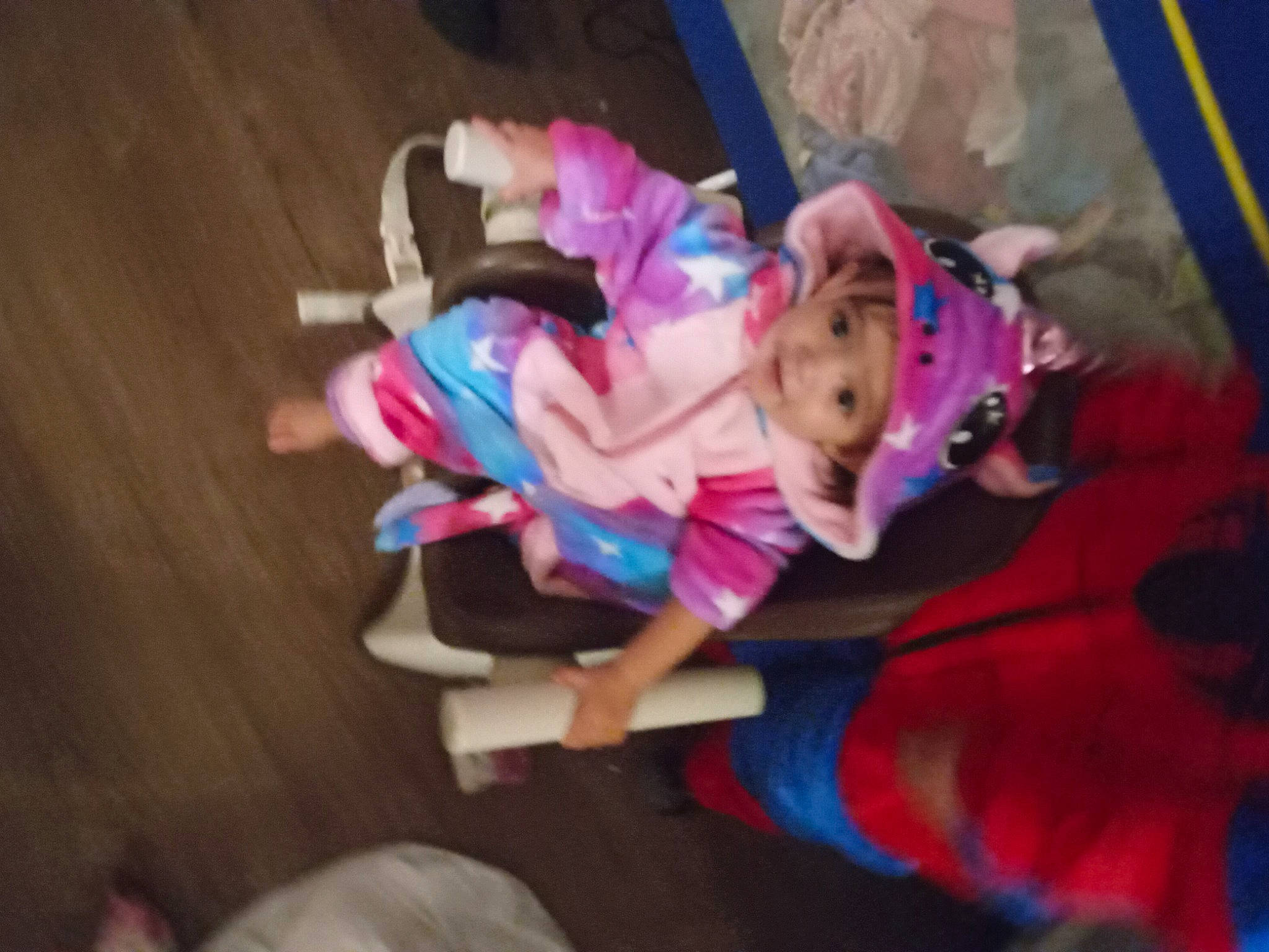 Emberly is registered to the contest to win money with this photo: child, costume, event, floor, flooring, fun, fur, hardwood, headwear, lap, magenta, person, plant, room, toddler, tree, wood