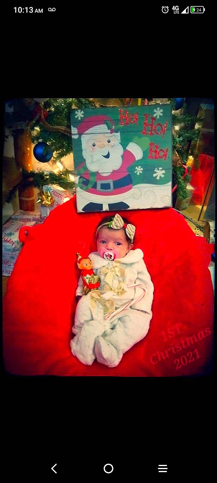 Emberly is registered to the contest to win money with this photo: art, baby, child, christmas, christmas_decoration, christmas_eve, christmas_ornament, event, fictional_character, happy, holiday, interior_design, lap, ornament, person, rectangle, room, santa_claus, toddler, tradition