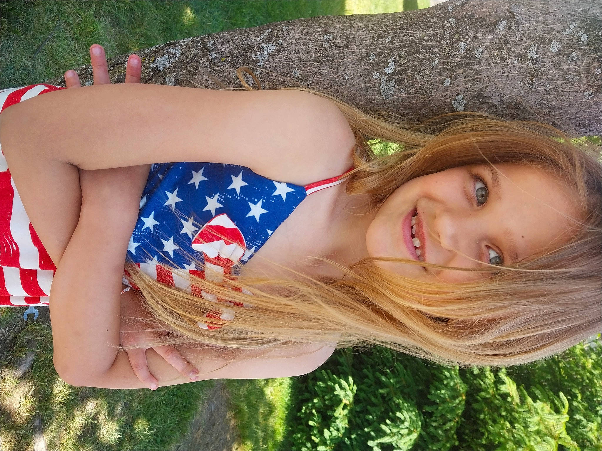 Jayde is registered to the contest to win money with this photo: abdomen, blond, brown_hair, elbow, electric_blue, facial_expression, flag_of_the_united_states, grass, hairstyle, happy, human_leg, joy, lip, long_hair, people_in_nature, person, shoulder, smile, summer, thigh
